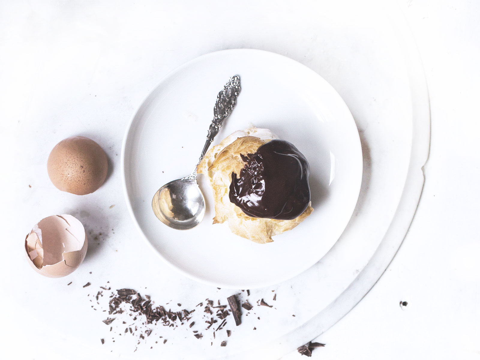 Chocolate profiteroles with vanilla sauce and chocolate slices